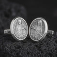 Load image into Gallery viewer, Polished silver Mary Magdalene cufflinks are displayed on black volcanic rock in a premium macro studio close-up with detailed Christian devotional artwork.
