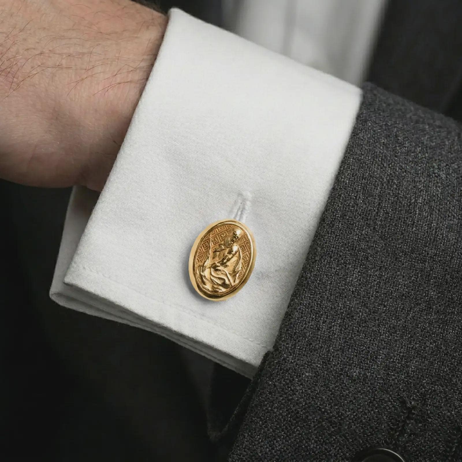 A gold plated Pensive Christ cufflink is worn on a white cuff in a close-up lifestyle shot, styled as a thoughtful religious gift for Christian men.