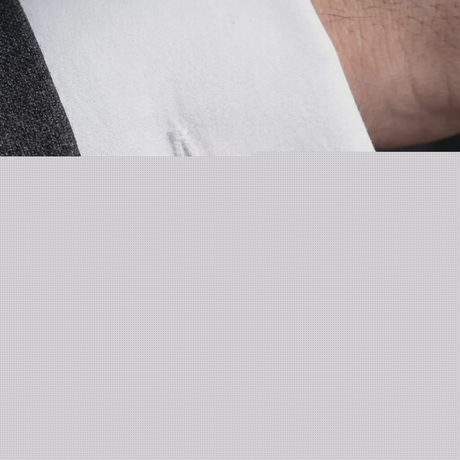 A rose gold plated Jesus Crown of Thorns cufflink is worn on a shirt cuff in a close-up lifestyle composition, highlighting its round frame and sacred Jesus design.