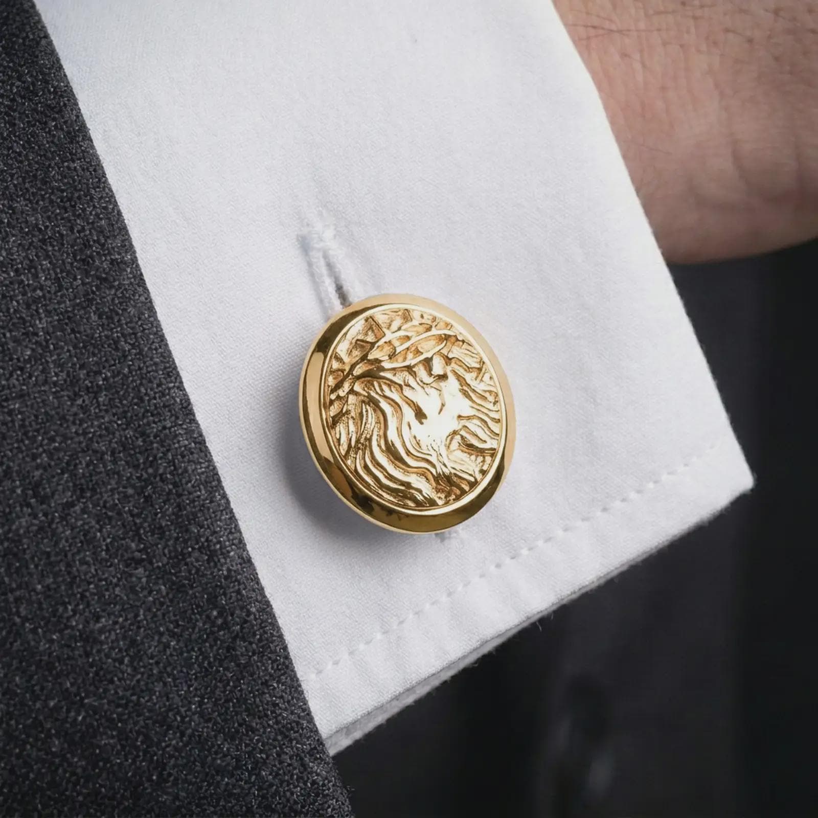 A gold plated Jesus Crown of Thorns cufflink is worn on a white cuff in a close-up lifestyle shot, styled as a thoughtful religious gift for Christian men.