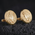 Load image into Gallery viewer, Gold plated Jesus Crown of Thorns cufflinks sit on textured volcanic rock in a dramatic studio macro shot, highlighting the sacred Christ medallion design.
