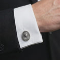 Load image into Gallery viewer, An oxidized Jesus Crown of Thorns cufflink is worn on a white shirt cuff in a close-up lifestyle shot, styled with a dark suit as a meaningful Christian accessory.
