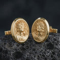 Load image into Gallery viewer, Gold plated Jesus Crown of Thorns cufflinks sit on textured volcanic rock in a dramatic studio macro shot, highlighting the sacred Christ portrait design.
