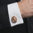 Load image into Gallery viewer, A rose gold plated Jesus Crown of Thorns cufflink is worn on a shirt cuff in a close-up lifestyle composition, highlighting its oval frame and sacred Jesus design.

