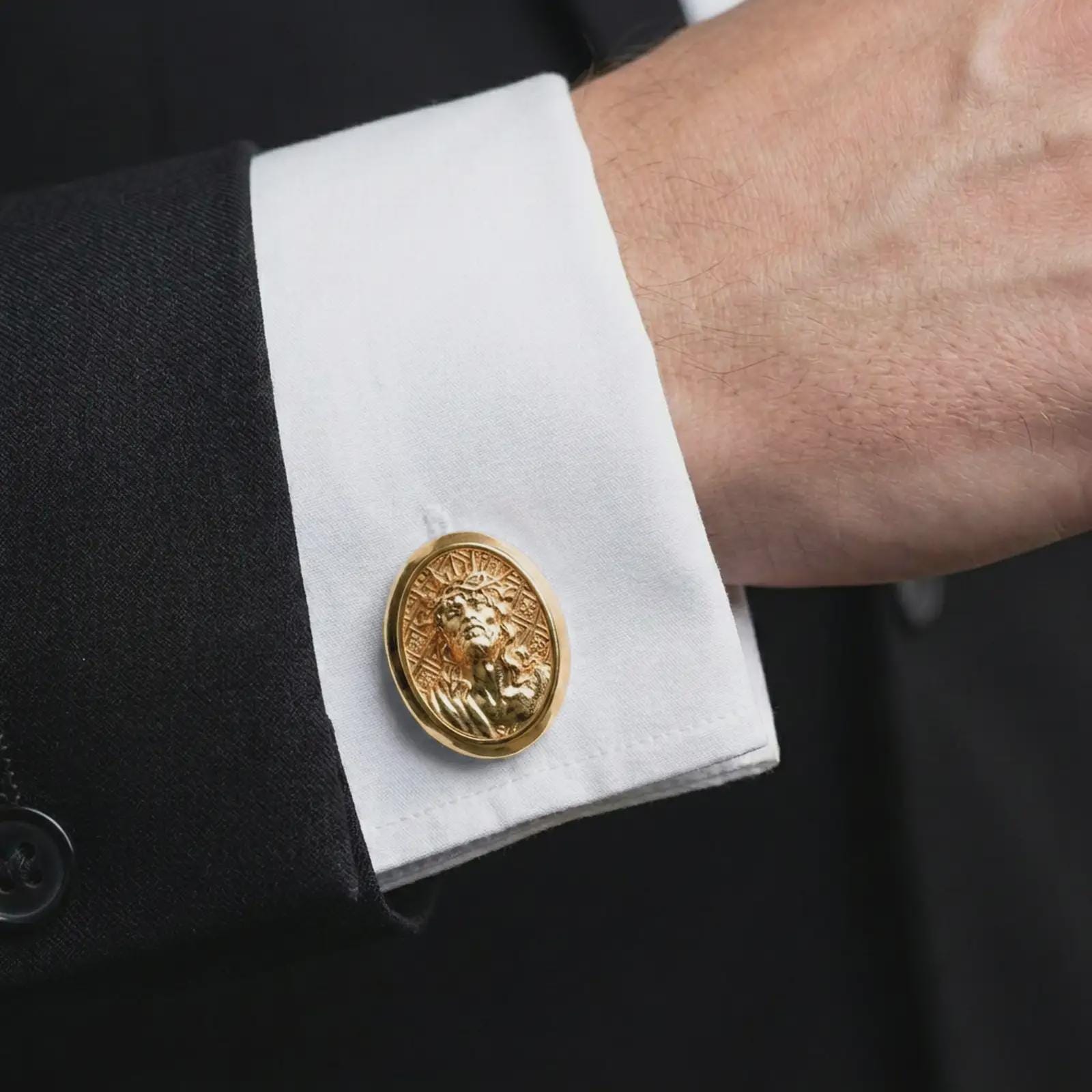 A gold plated Jesus Crown of Thorns cufflink is worn on a white cuff in a close-up lifestyle shot, styled as a thoughtful Catholic gift for men.