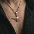 Load image into Gallery viewer, Rose gold plated Faravahar pendant necklace worn on the chest, close-up lifestyle shot featuring the ancient Faravahar symbol with warm rose gold tones.
