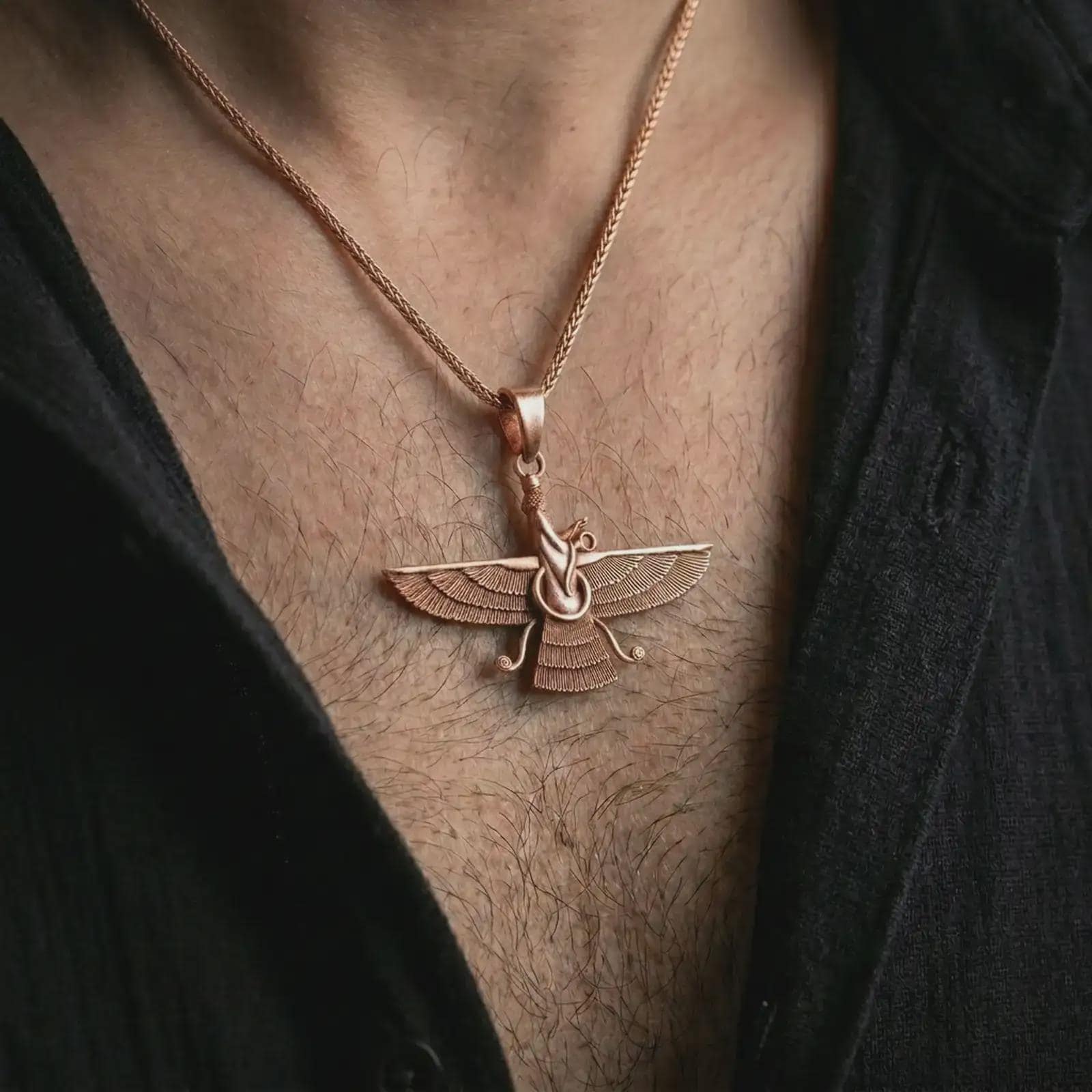 Rose gold plated Faravahar pendant necklace worn on the chest, close-up lifestyle shot featuring the ancient Faravahar symbol with warm rose gold tones.