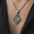 Load image into Gallery viewer, An oxidized Tree of Life cross pendant is worn on the neck in a close-up lifestyle shot, centered on the chest as a meaningful nature and faith necklace.
