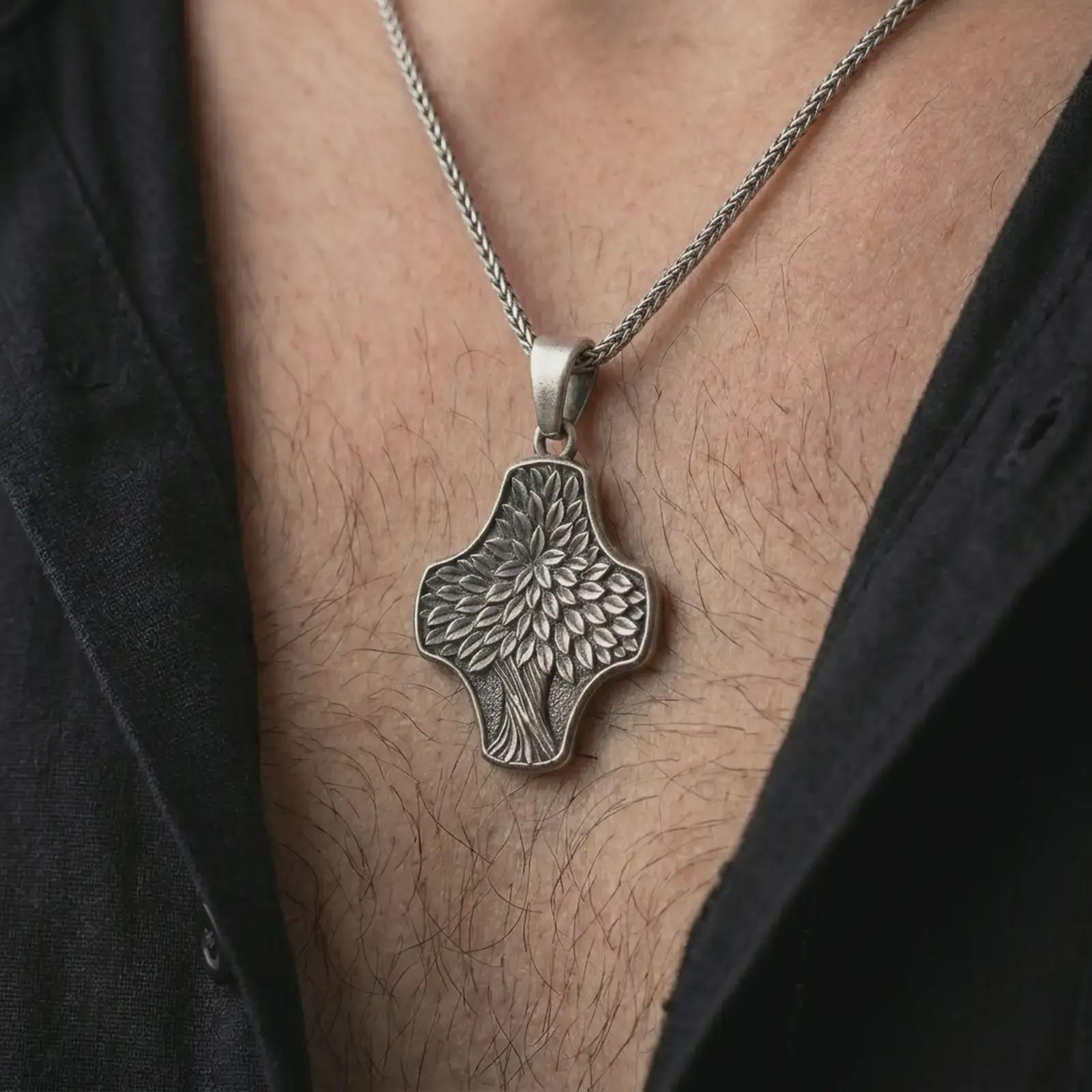 An oxidized Tree of Life cross pendant is worn on the neck in a close-up lifestyle shot, centered on the chest as a meaningful nature and faith necklace.