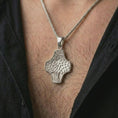 Load image into Gallery viewer, A polished silver Tree of Life cross pendant is worn on the neck in a premium close-up lifestyle image, showing the organic leaf pattern clearly.
