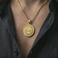 Load image into Gallery viewer, Gold plated all-seeing eye pendant necklace worn on the chest, premium lifestyle jewelry photo with the Illuminati-style pendant centered on a spiga chain.
