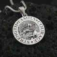 Load image into Gallery viewer, Polished silver Spartan warrior pendant necklace on textured volcanic rock, centered macro jewelry photo with detailed warrior armor, round medallion frame, and bright silver highlights.
