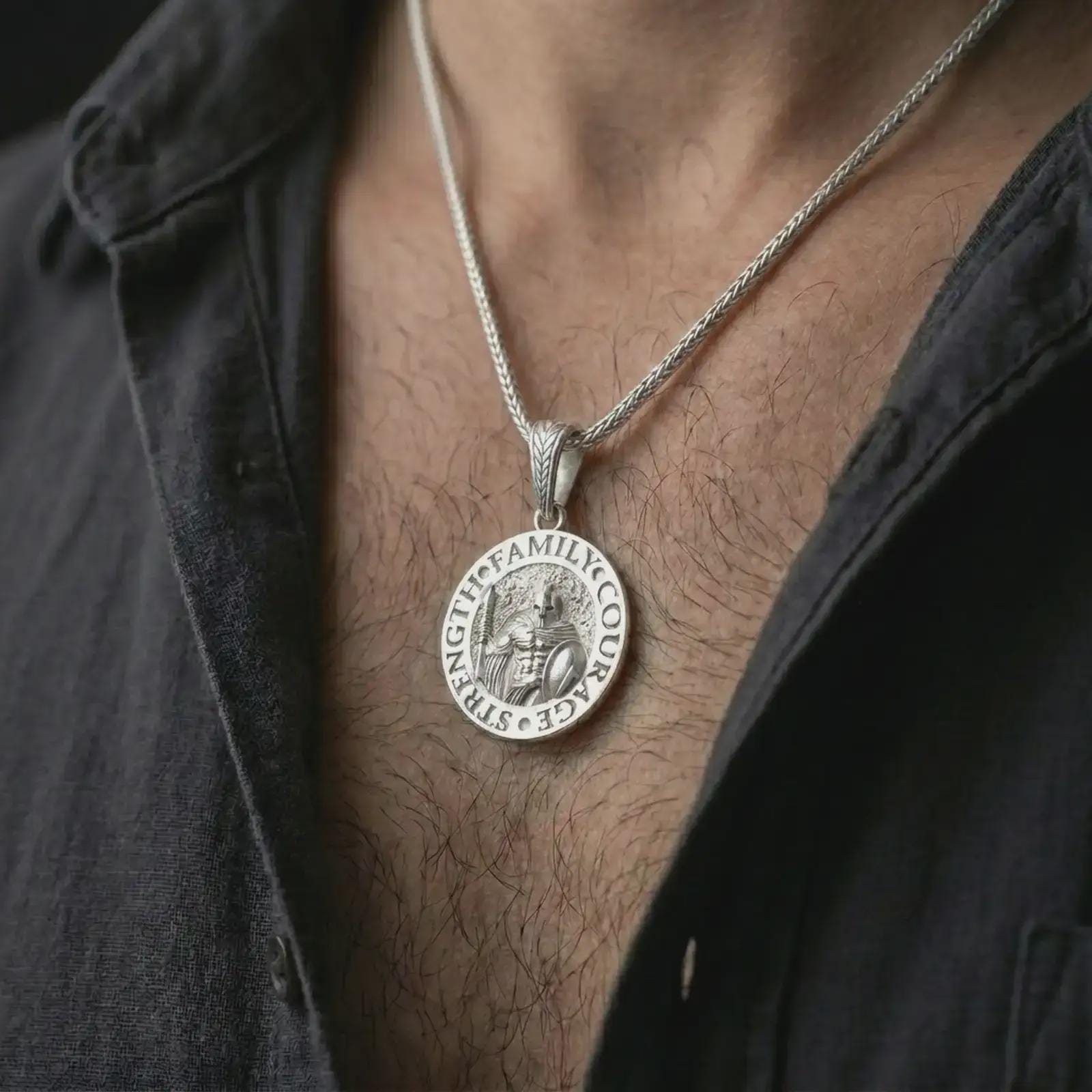 Polished silver Spartan warrior pendant necklace worn on the chest, masculine lifestyle shot highlighting the bright silver finish, sculpted armor, shield, and spear details.