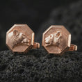 Load image into Gallery viewer, Rose gold plated lioness head cufflinks are photographed on porous volcanic rock in a close-up studio composition with refined luxury lighting and detailed lioness features.
