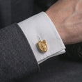 Load image into Gallery viewer, A gold plated Saint Michael cufflink is worn on a white cuff in a close-up lifestyle shot, styled as a thoughtful protection gift for Catholic men.
