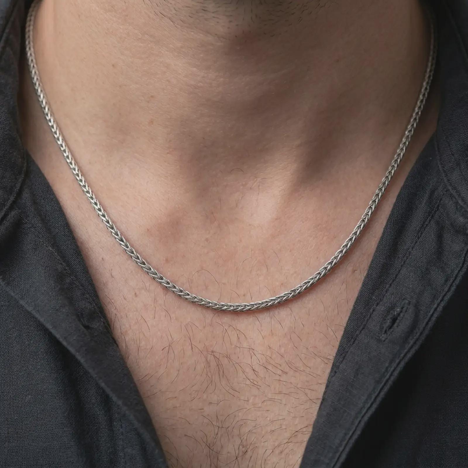 A polished silver foxtail chain necklace is worn on the neck in a premium close-up lifestyle image, showing the 2.70mm woven pattern clearly.