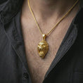 Load image into Gallery viewer, A gold plated gorilla pendant is worn on the neck in a close-up lifestyle shot, styled as a powerful strength symbol gift for men.
