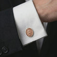 Load image into Gallery viewer, A rose gold plated Our Lady of Guadalupe cufflink is worn on a shirt cuff in a close-up lifestyle composition, highlighting its oval frame and Catholic devotional design.
