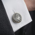 Load image into Gallery viewer, An oxidized Jesus Crown of Thorns cufflink is worn on a white shirt cuff in a close-up lifestyle shot, styled with a dark suit as a meaningful Christian accessory.
