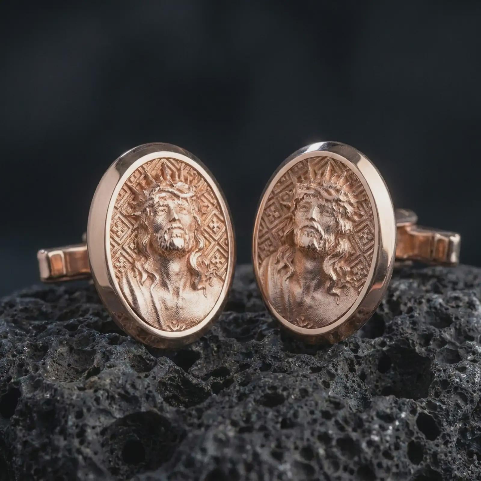 Rose gold plated Jesus Crown of Thorns cufflinks are photographed on porous volcanic rock in a close-up studio composition with refined luxury lighting and religious detail.