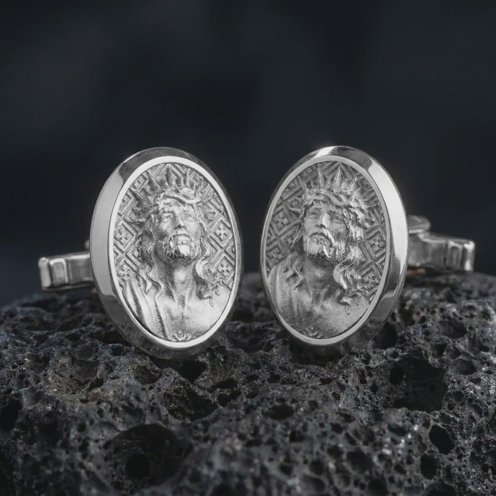 Polished silver Jesus Crown of Thorns cufflinks are displayed on black volcanic rock in a premium macro studio close-up with detailed Christian devotional artwork.