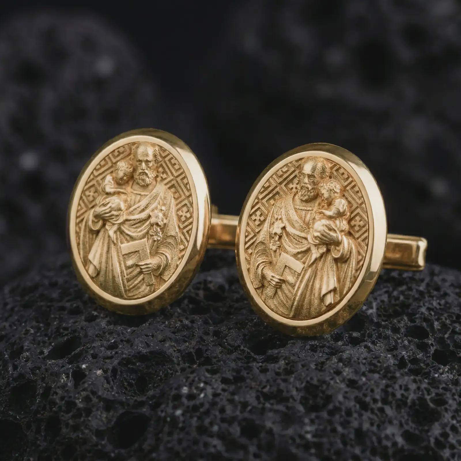 Gold plated Saint Joseph cufflinks photographed on black volcanic stone in a luxury studio close-up, emphasizing the patron saint carrying the Christ Child.