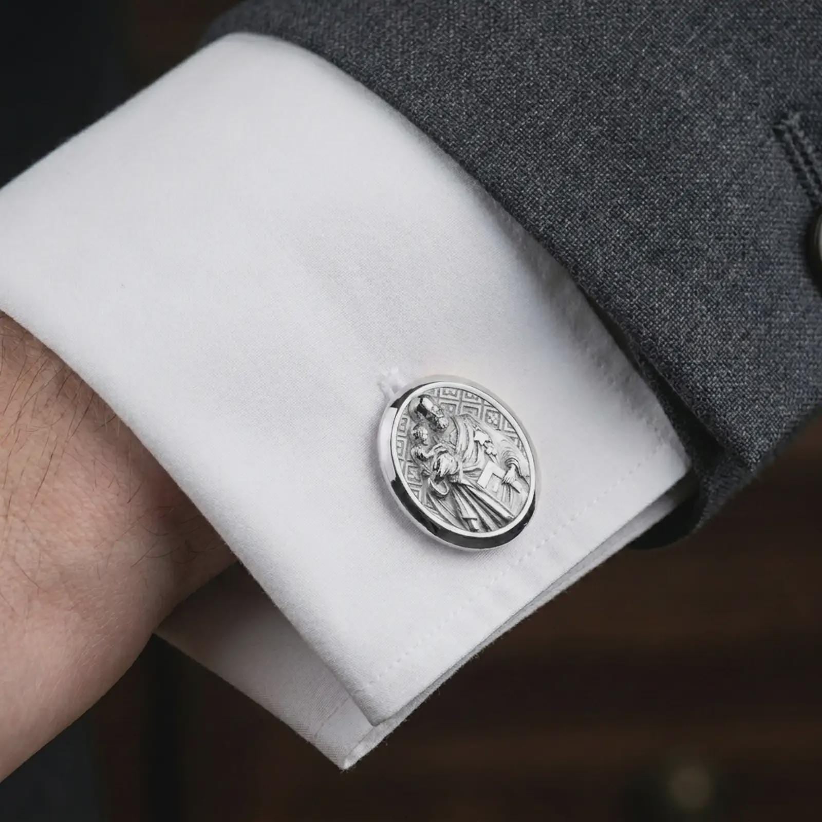 Polished silver Saint Joseph cufflinks styled on a formal shirt cuff in a close-up lifestyle image, highlighting the detailed Catholic saint engraving during formal wear.
