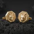 Load image into Gallery viewer, Gold plated fox head cufflinks sit on textured volcanic rock in a dramatic studio macro shot, highlighting the clever animal motif and formal accessory design.
