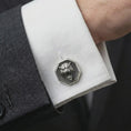 Load image into Gallery viewer, An oxidized tiger head cufflink is worn on a white shirt cuff in a close-up lifestyle shot, styled with a dark suit for a bold formal look.
