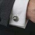 Load image into Gallery viewer, An oxidized lioness head cufflink is worn on a white shirt cuff in a close-up lifestyle shot, styled with a dark suit for a refined wildlife-inspired look.
