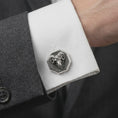 Load image into Gallery viewer, An oxidized ram head cufflink is worn on a white shirt cuff in a close-up lifestyle shot, styled with a dark suit for a bold masculine look.
