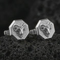 Load image into Gallery viewer, Polished silver ram head cufflinks are displayed on black volcanic rock in a premium macro studio close-up with detailed horn texture and clean geometric edges.
