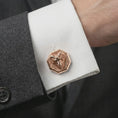 Load image into Gallery viewer, A rose gold plated ram head cufflink is worn on a shirt cuff in a close-up lifestyle composition, highlighting its octagon frame and powerful ram design.
