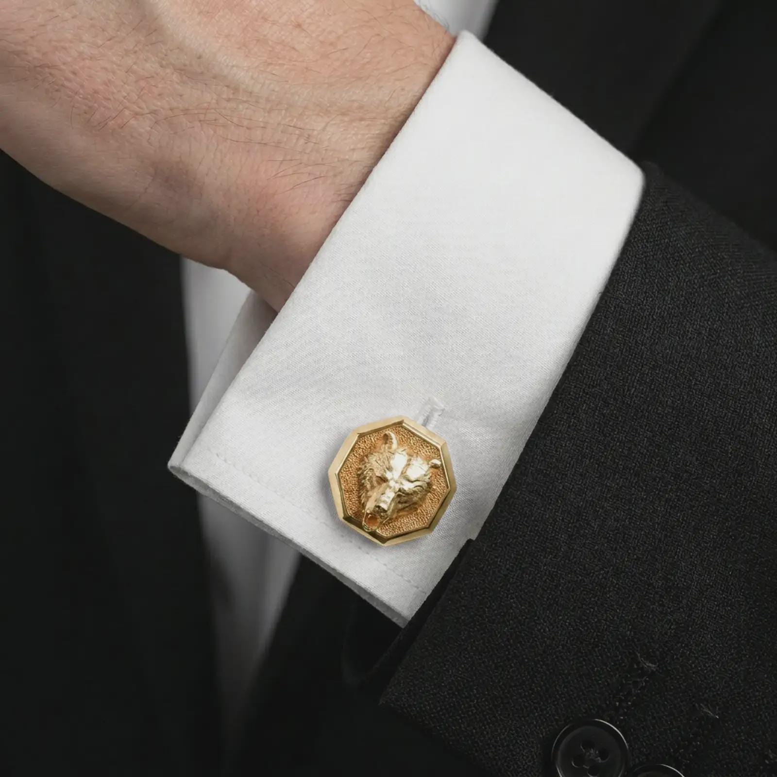 A gold plated bear head cufflink is worn on a white cuff in a close-up lifestyle shot, styled as a meaningful wildlife gift for men.