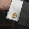 Load image into Gallery viewer, A gold plated Virgin Mary cufflink is worn on a white cuff in a close-up lifestyle shot, styled as a thoughtful religious gift for Catholic men.
