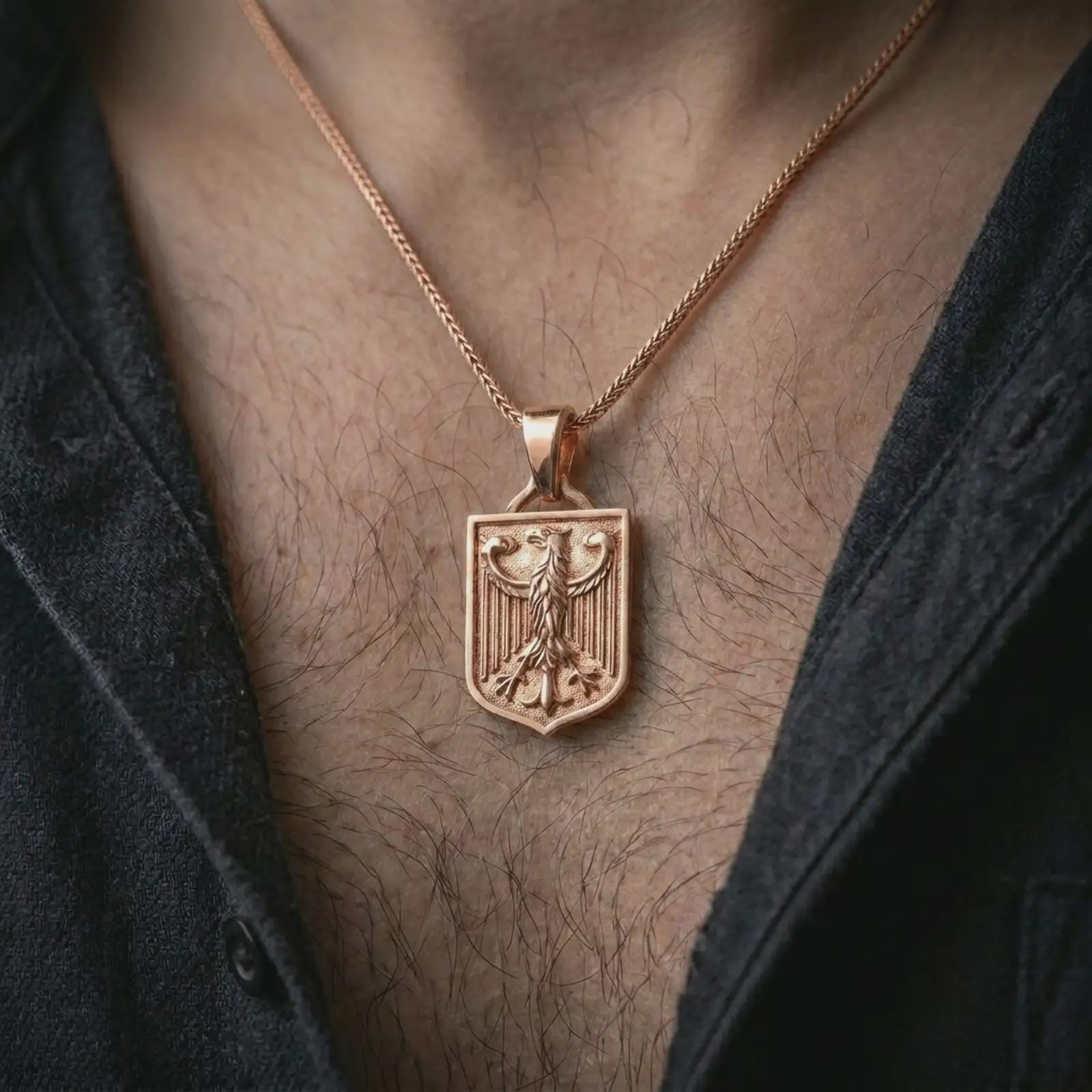 Rose gold plated German eagle shield pendant necklace worn on the chest, close-up lifestyle shot featuring the bold heraldic eagle design with warm rose gold tones.