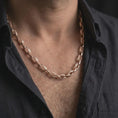 Load image into Gallery viewer, Rose gold plated Greek key chain necklace is worn on the neck in a close-up lifestyle composition, highlighting its geometric chain pattern and refined finish.
