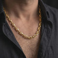 Load image into Gallery viewer, Gold plated Greek key chain necklace is worn on the neck in a close-up lifestyle shot, styled as a meaningful ancient-inspired gift for men.
