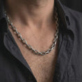 Load image into Gallery viewer, Oxidized Greek key chain necklace is worn on the neck in a close-up lifestyle shot, styled as a masculine everyday silver chain.
