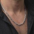 Load image into Gallery viewer, Polished silver Greek key chain necklace is worn on the neck in a premium close-up lifestyle image, showing the detailed meander link structure.
