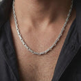 Load image into Gallery viewer, Polished silver Greek key chain necklace worn on a male model, showing the clean shine, link texture, and refined everyday chain proportion.

