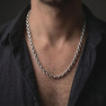 Load image into Gallery viewer, Polished silver circle link chain worn in a close-up lifestyle shot, showing its refined shine and structured link pattern.
