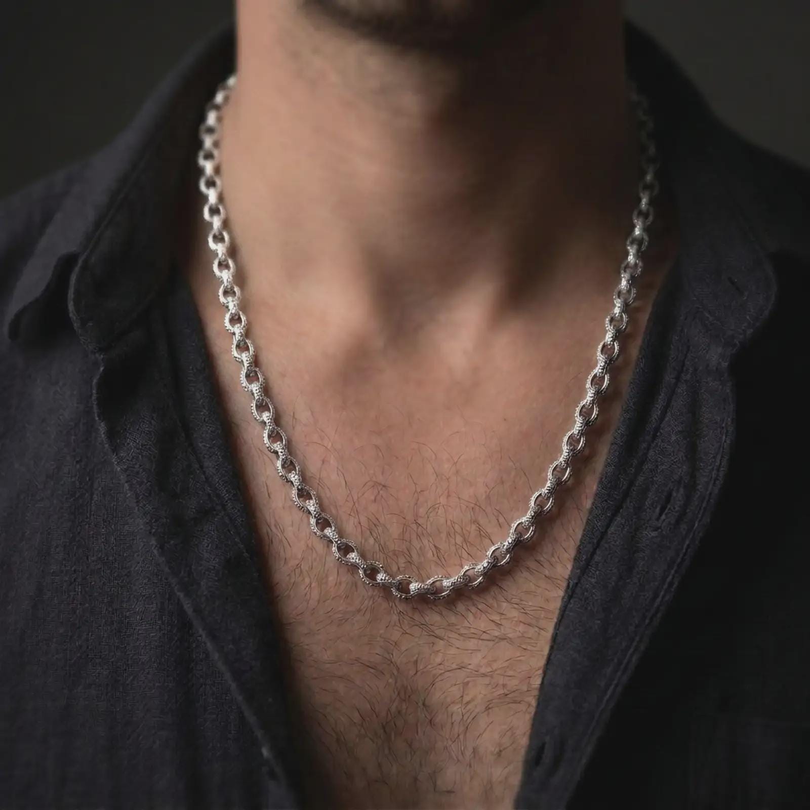Polished silver circle link chain worn in a close-up lifestyle shot, showing its refined shine and structured link pattern.