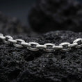Load image into Gallery viewer, Oxidized sterling silver anchor link chain displayed on black volcanic rock, showing its rugged oval link construction.
