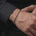 Load image into Gallery viewer, Rose gold plated box chain bracelet worn on the wrist, styled as a narrow masculine bracelet with soft warm metallic contrast.
