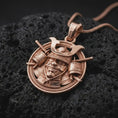Load image into Gallery viewer, The rose gold plated Bushido warrior pendant is arranged on rugged black volcanic rock, emphasizing the detailed kabuto helmet, protective mask, shoulder armor, and braided border in a refined macro image.

