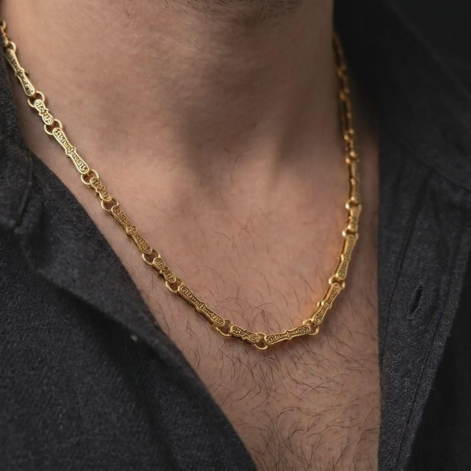 Gold plated Greek key chain necklace is worn on the neck in a close-up lifestyle shot, styled as a meaningful Greek-inspired gift for men.