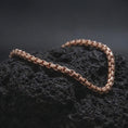 Load image into Gallery viewer, Rose gold plated square link bracelet displayed on lava stone, combining warm tone with a structured low-profile chain design.
