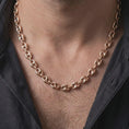 Load image into Gallery viewer, The rose gold plated 11mm mariner chain necklace is worn naturally on a man’s chest, showcasing its dimensional anchor links and bold masculine proportions in an elegant lifestyle shot.
