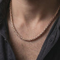 Load image into Gallery viewer, The rose gold plated square Byzantine necklace is worn naturally on a man’s chest, showcasing the 5mm interlocking chain structure, dimensional shine, and masculine jewelry design.
